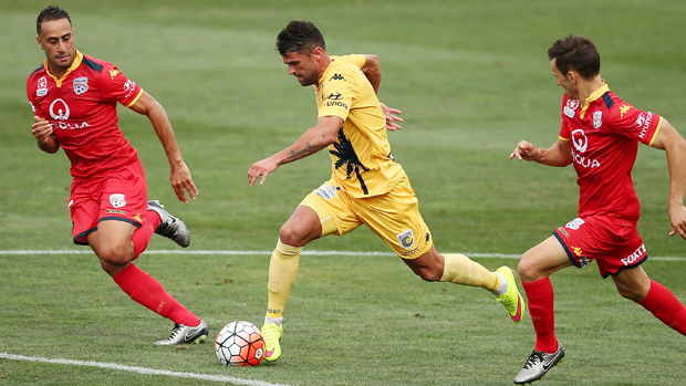 Mariners winger Fabio Ferreira dribbles with the ball alongside Reds defenders Tarek Elrich and Isaias.