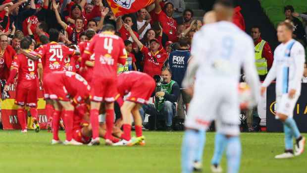 Adelaide United players celebrate opening the scoring against City at AAMI Park.