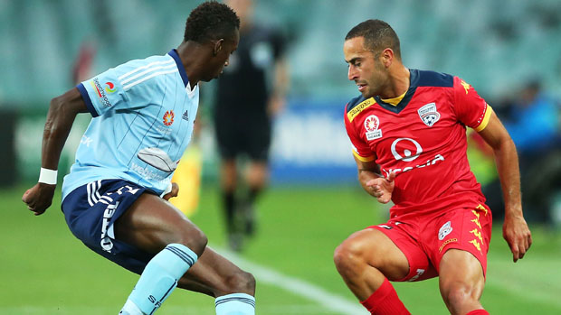 Reds defender Tarek Elrich challenges for the ball with Sydney FC striker Bernie Ibini.
